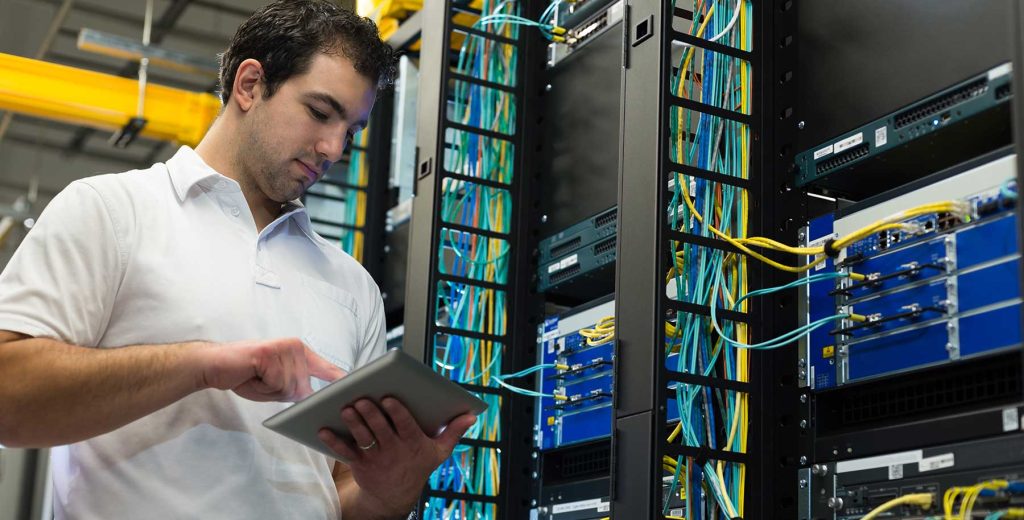 IT Technician Working on Network Equipment